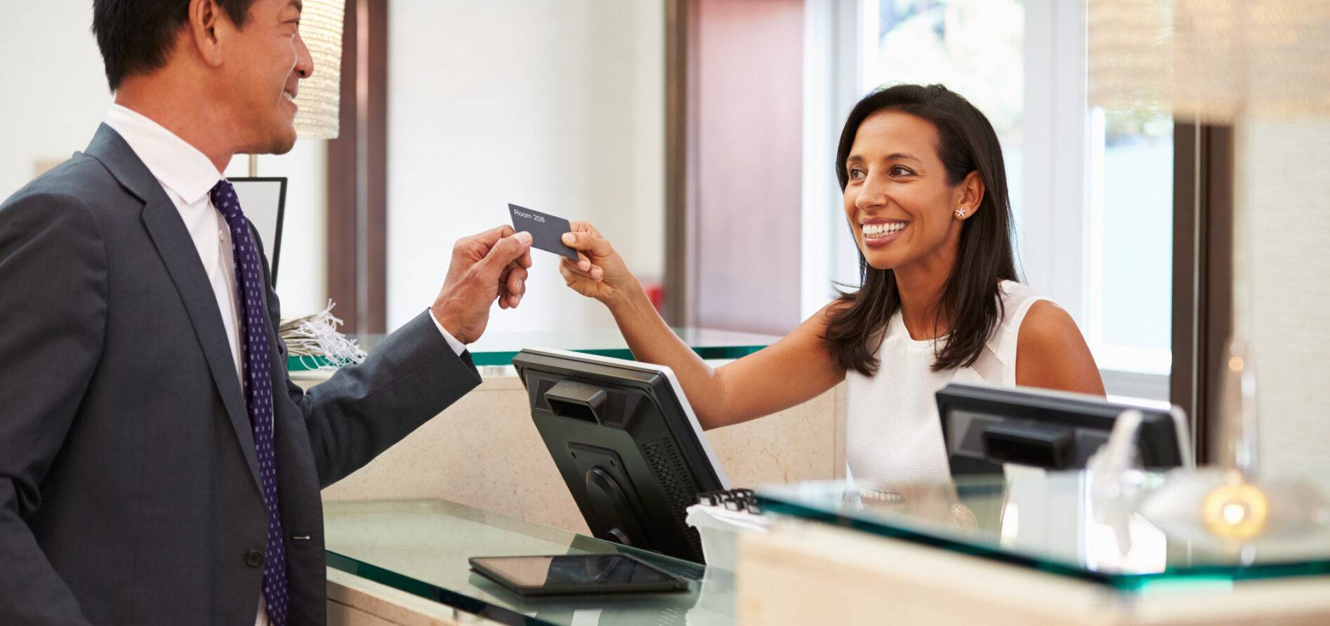 A man checking into a hotel