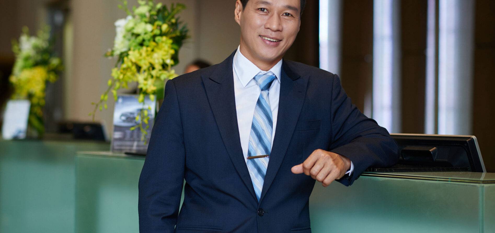A man posing in a hotel