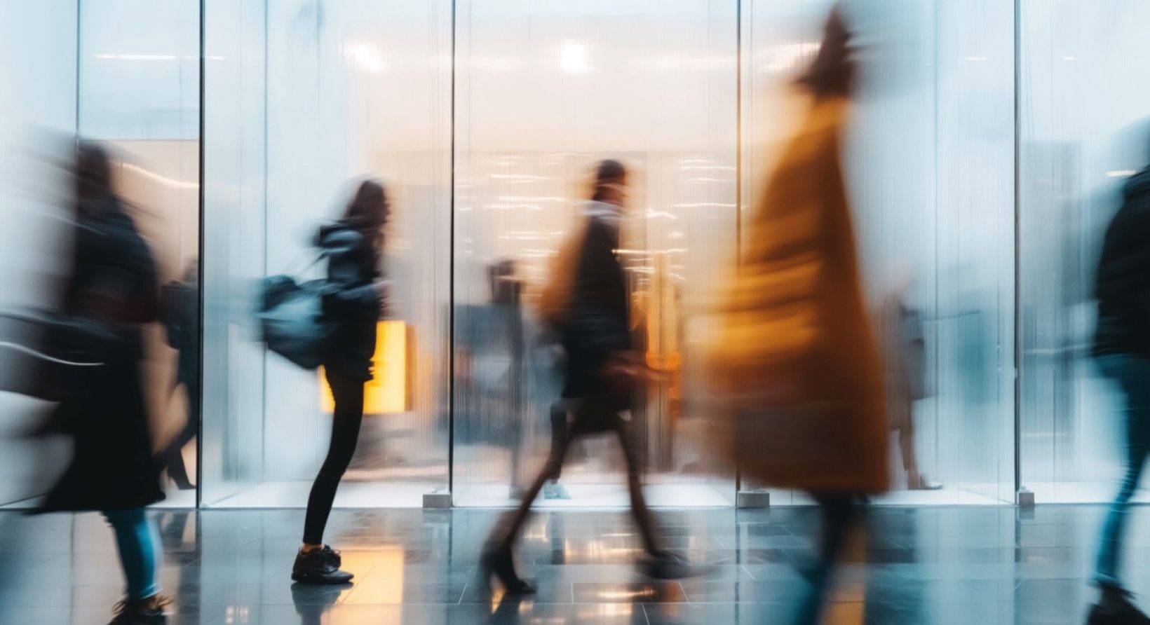 people rushing through a busy hallway