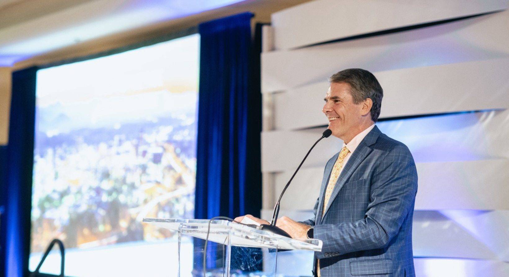 Andrew Carey giving a speech