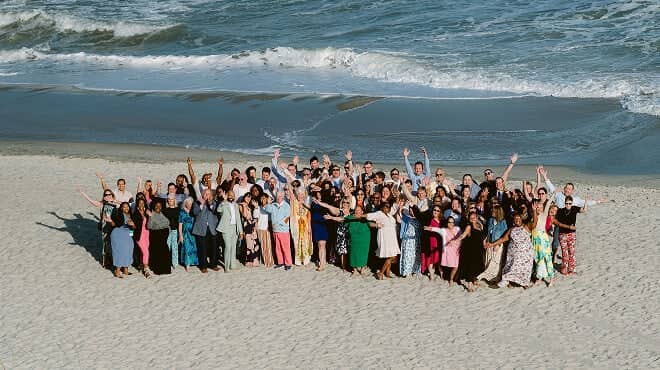 The NHG team posing for a group photo on the beach