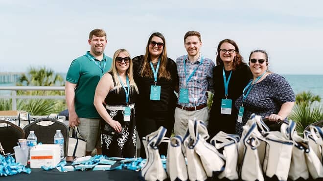 A group of retreat leaders posing by the ocean