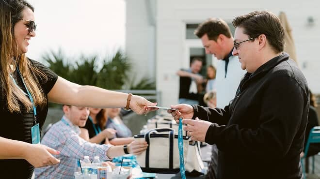 A retreat guest receiving a name badge