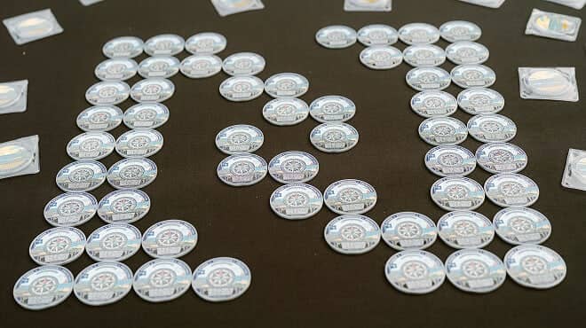 coins arranged in the Newport Hospitality Group logo