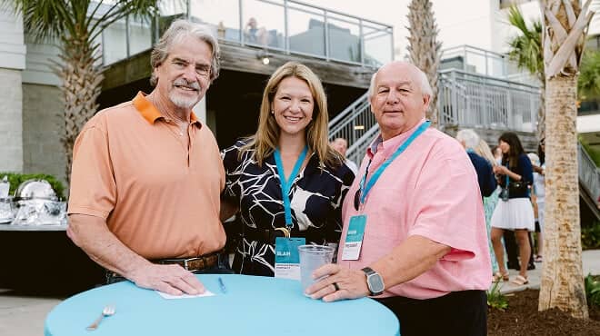 Three people at the 2026 NHG leadership retreat