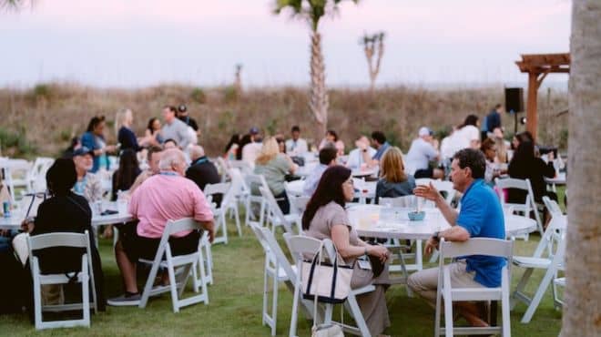 Retreat members sitting at outdoor tables