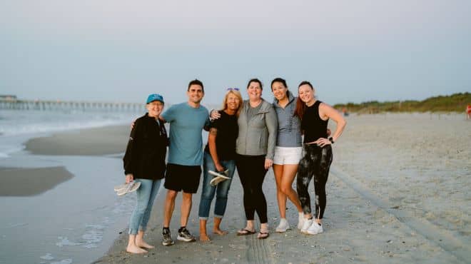 Retreat members posing together on the beach
