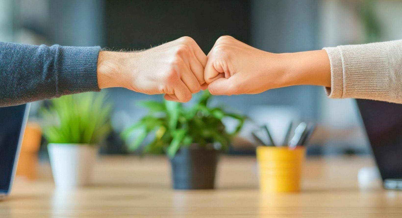Two people fist bumping