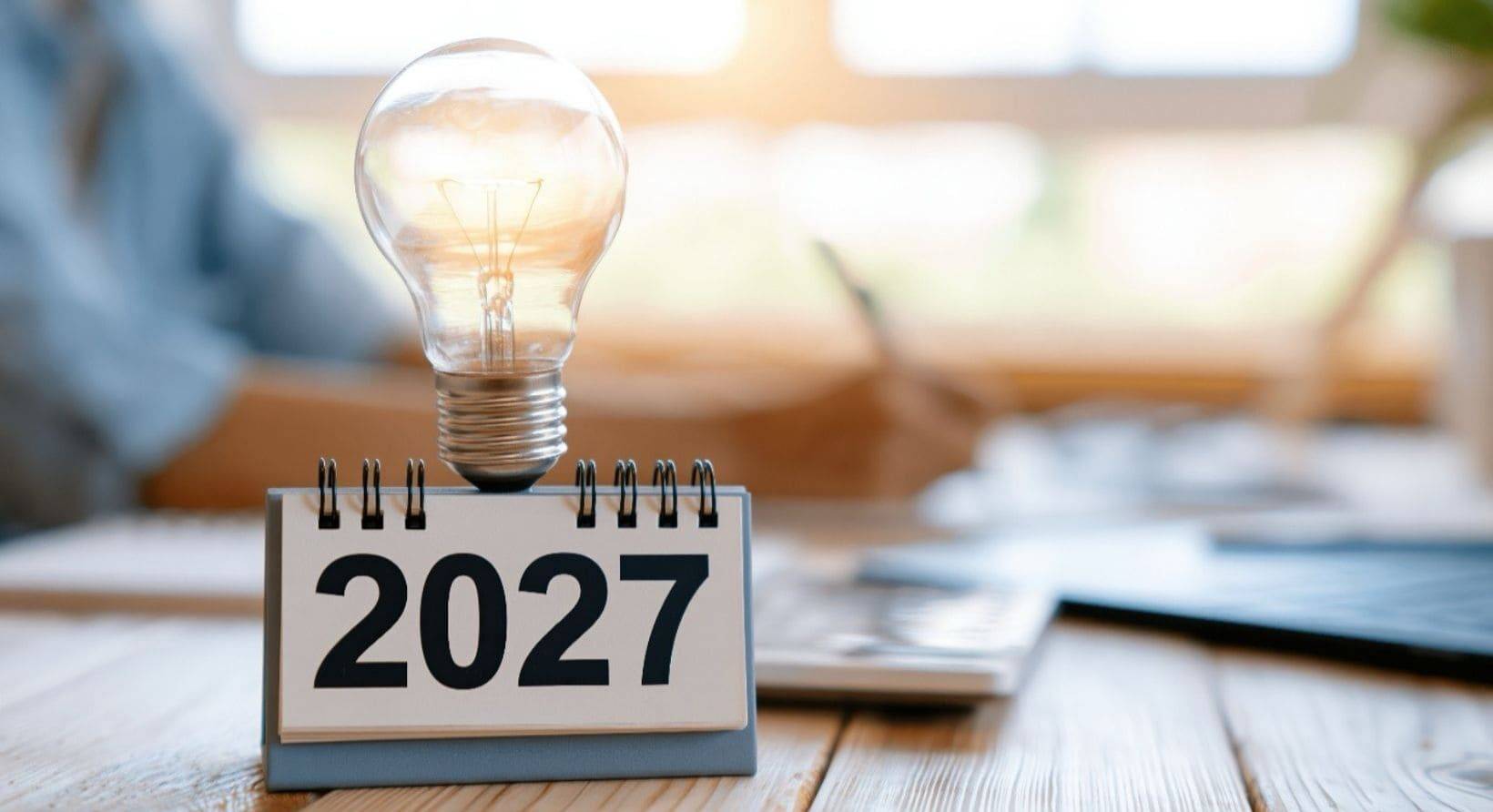 A lightbulb on top of a 2027 desk calendar