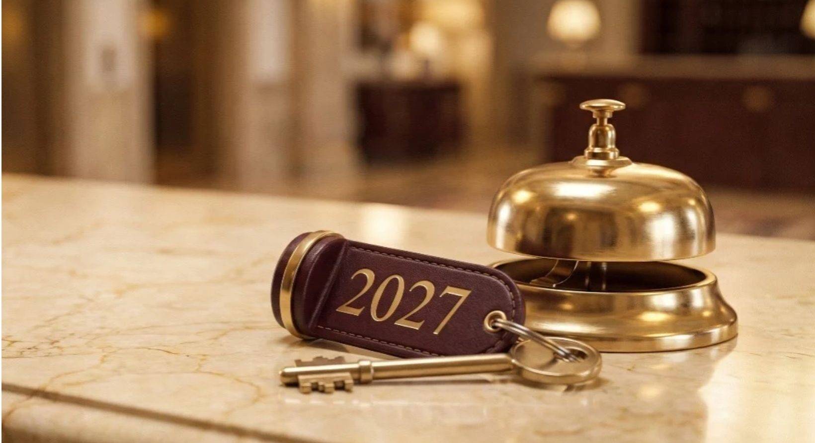 A key and bell on a hotel lobby desk
