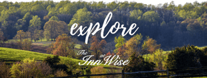 a sign that says explore in front of a forest