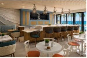 a modern hotel café and bar area with seating