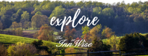 a sign that says explore in front of a forest
